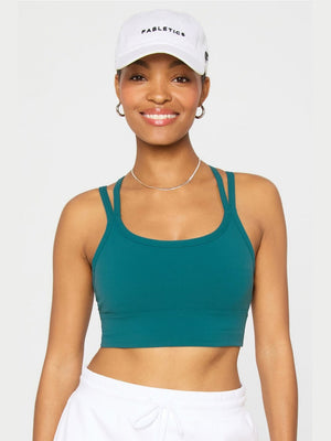 Fabletics Principal Longline Sports Bra in teal green with wide double-strapped racerback and thick band