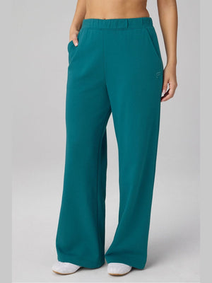Teal wide-leg sweatpants in recycled Year Round Terry fabric with elastic waistband, deep pockets, and embroidered logo