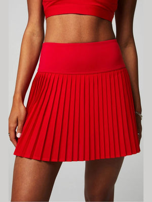 Fabletics Hot Shot pleated mini skirt in vibrant red with high-waisted elastic waistband and flared hem